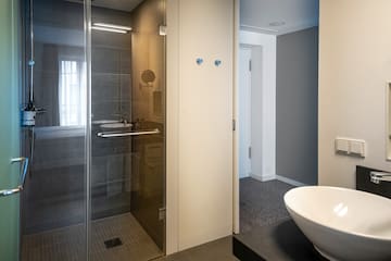 a bathroom with a glass shower and sink