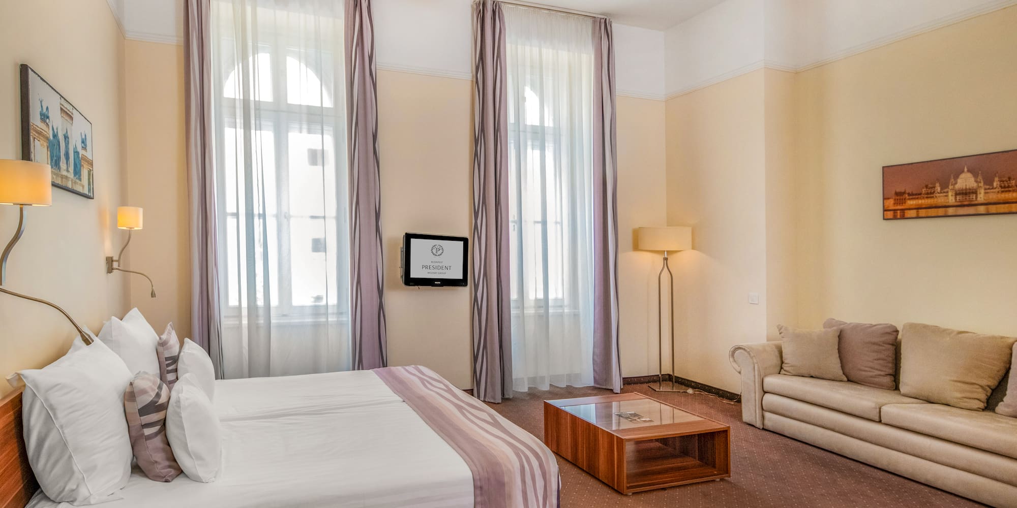 a room with a bed and couches