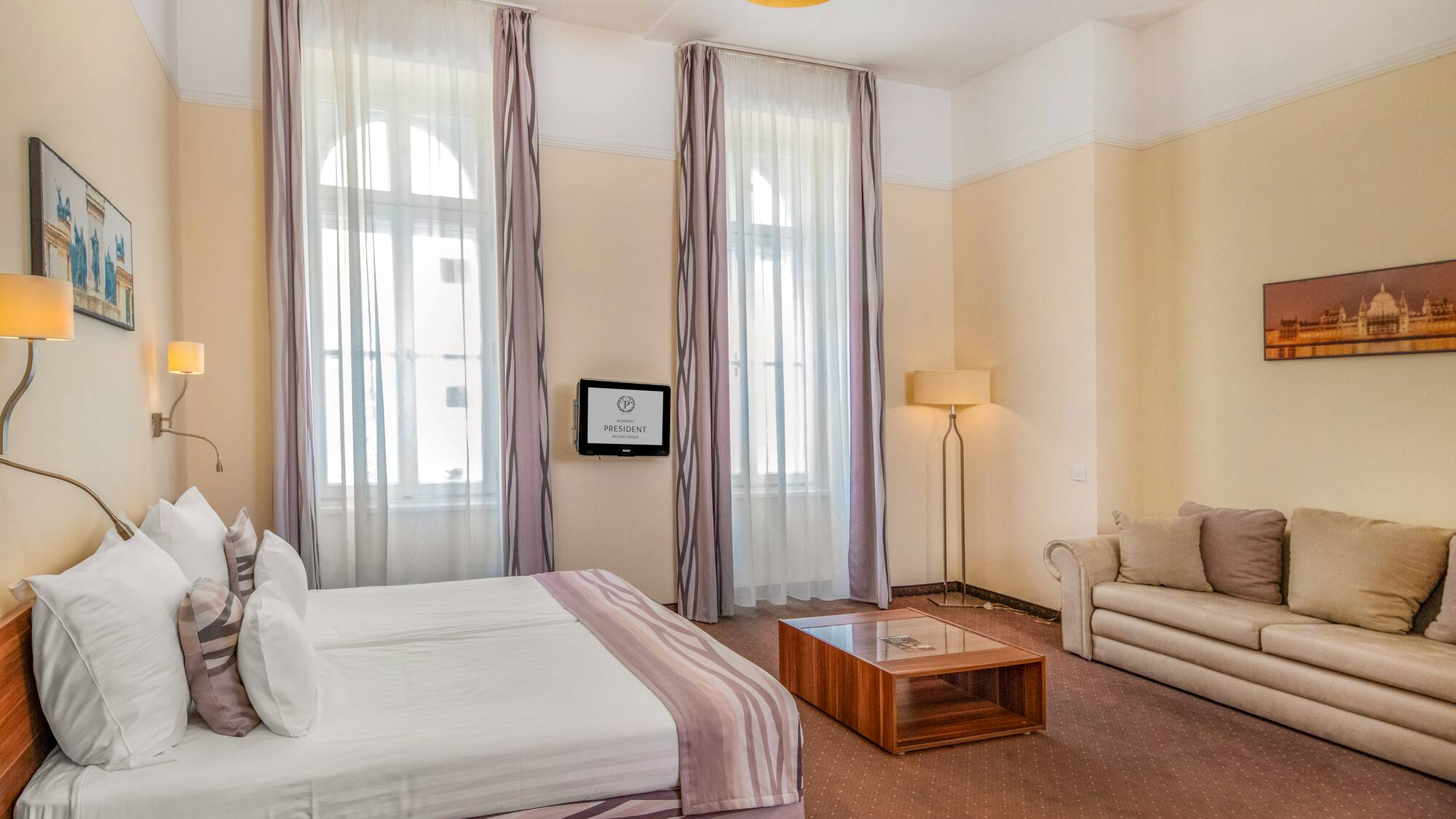 a room with a bed and couches