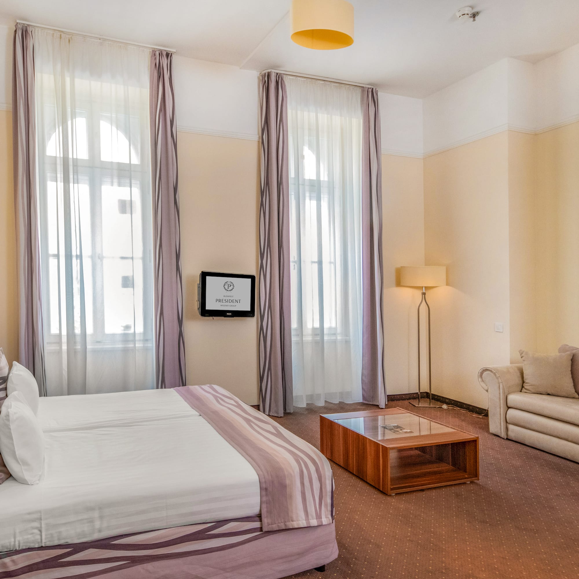 a room with a bed and couches