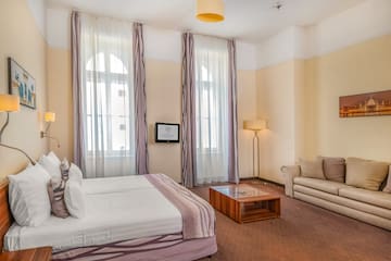 a room with a bed and couches