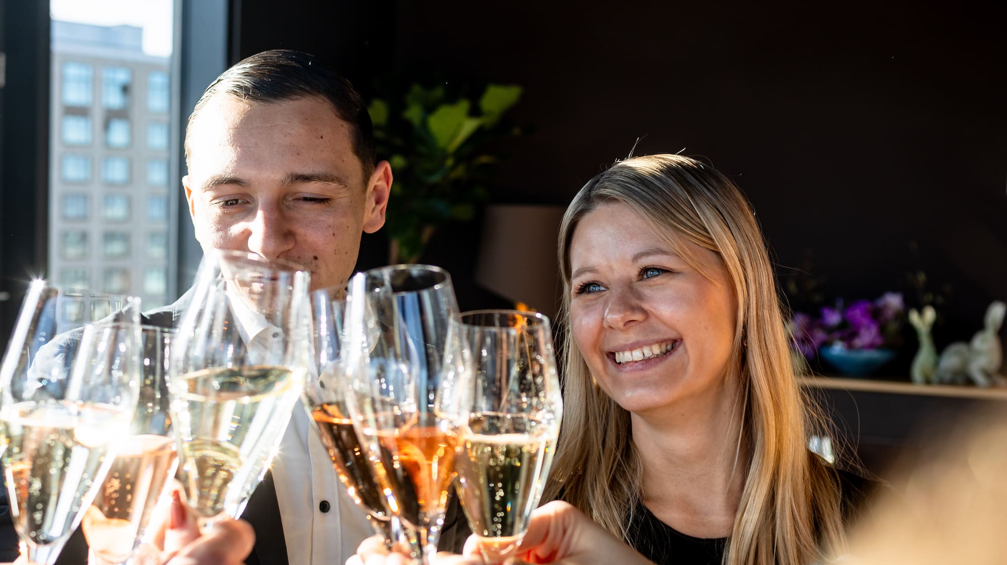a group of people clinking glasses of champagne
