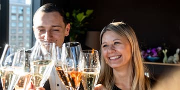 a group of people clinking glasses of champagne