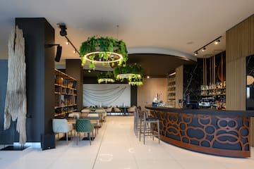 a room with a bar and chairs