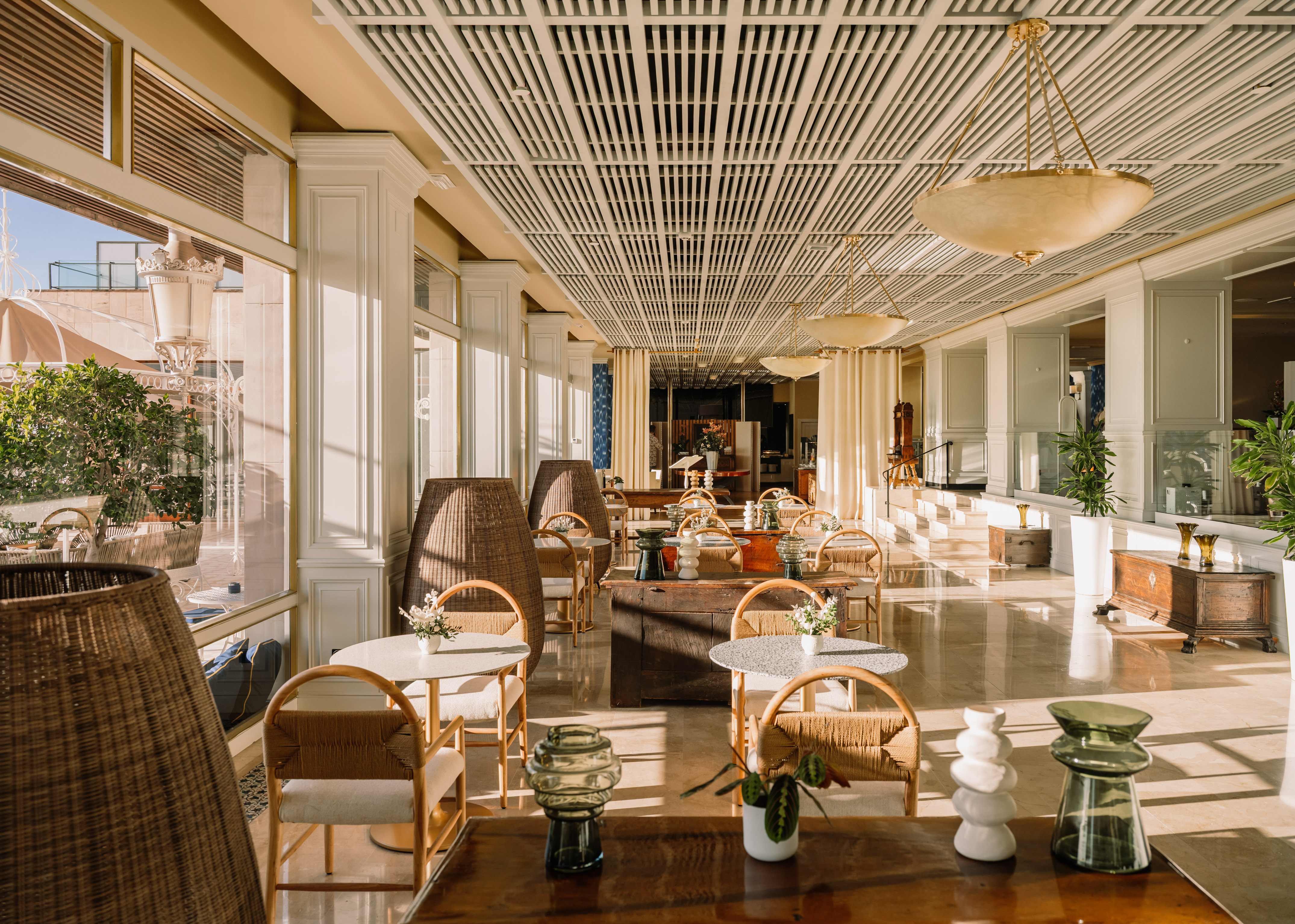 Bright hotel dining area with elegant modern design and natural light.