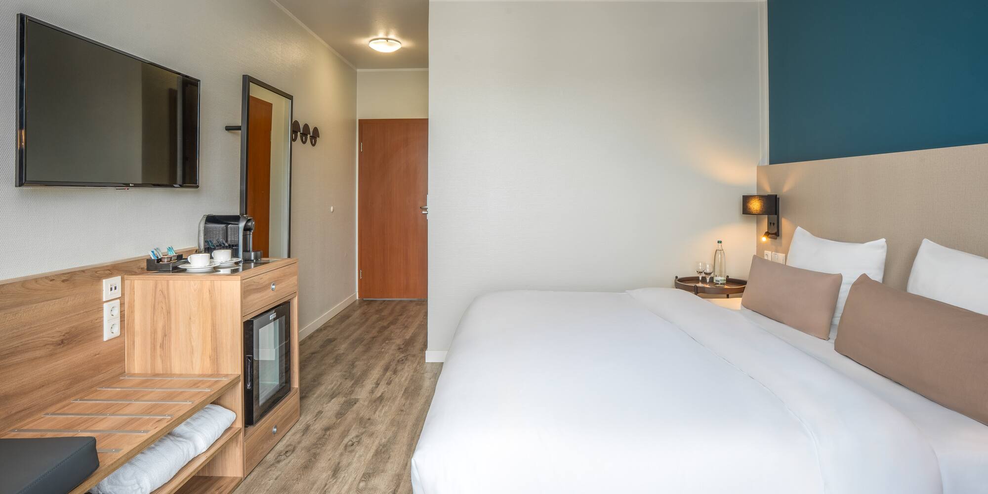 a room with a bed and a television