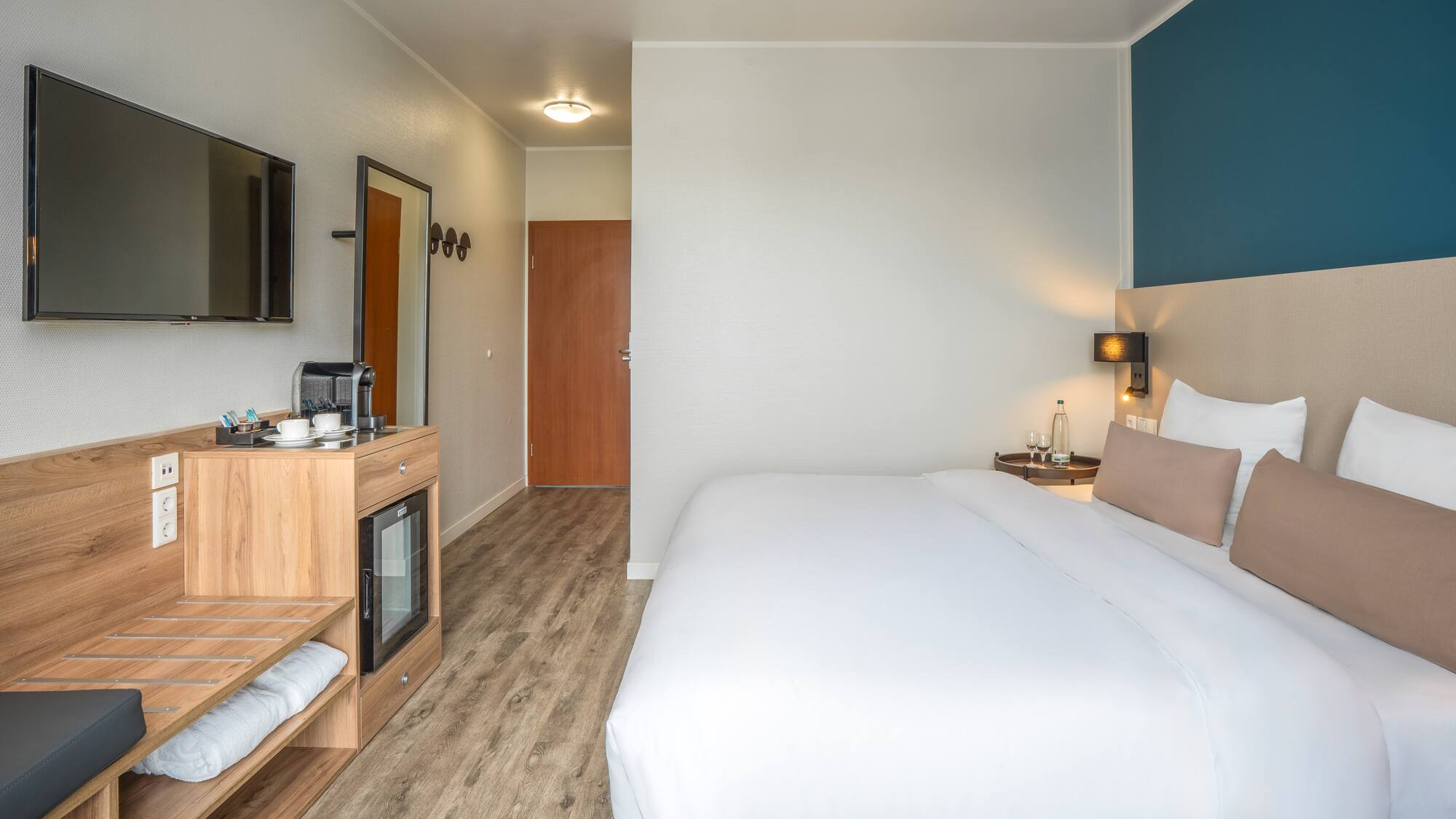 a room with a bed and a television