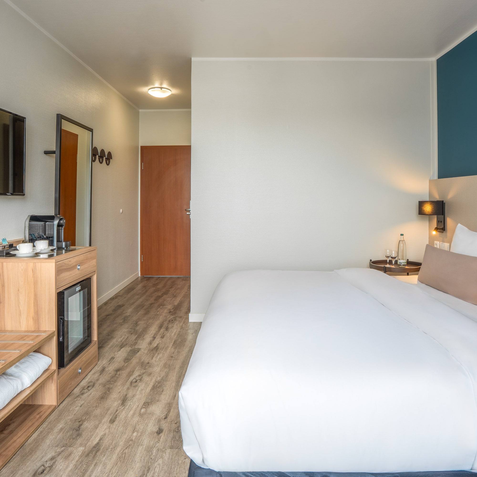 a room with a bed and a television