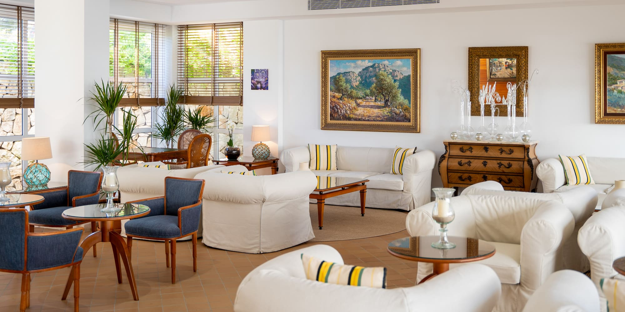 a room with white furniture and art