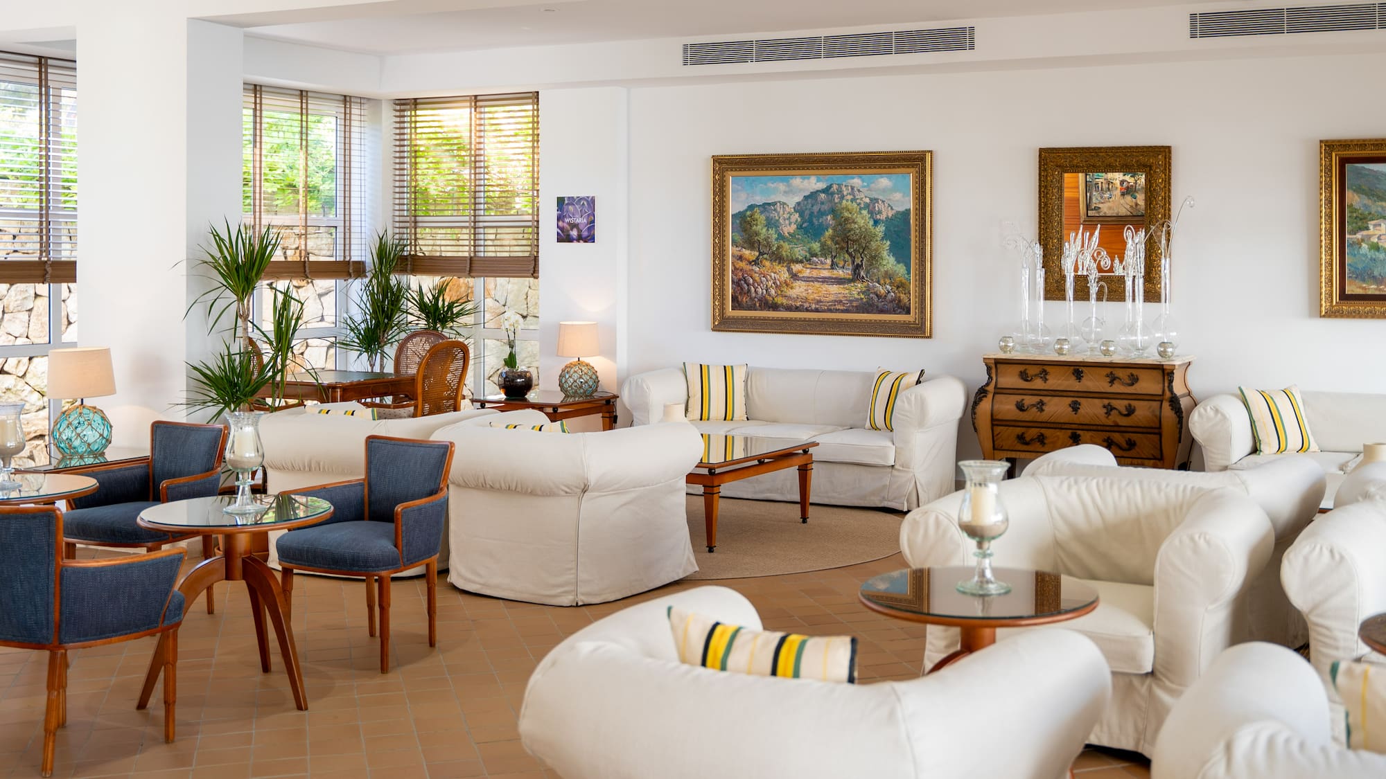 a room with white furniture and art