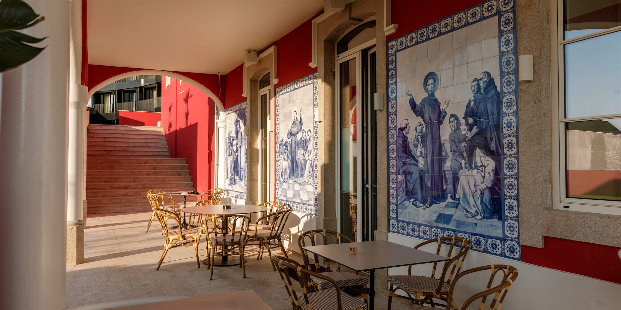 a red building with tables and chairs