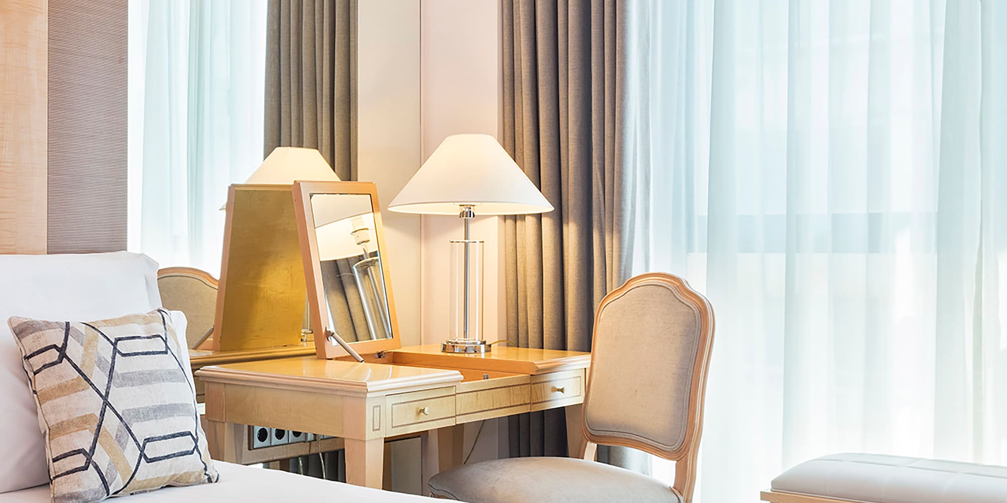 a bedroom with a desk and a mirror