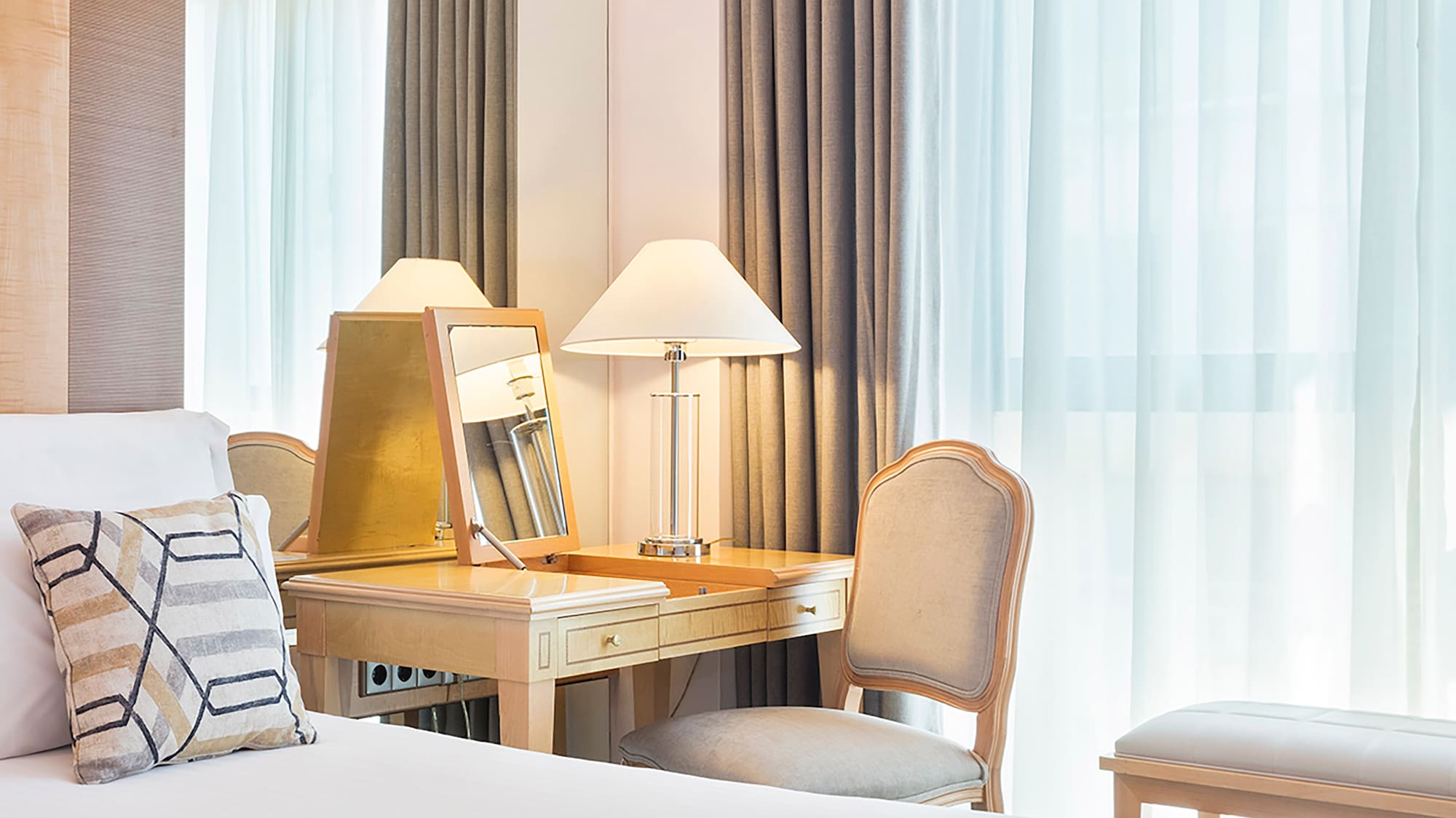 a bedroom with a desk and a mirror