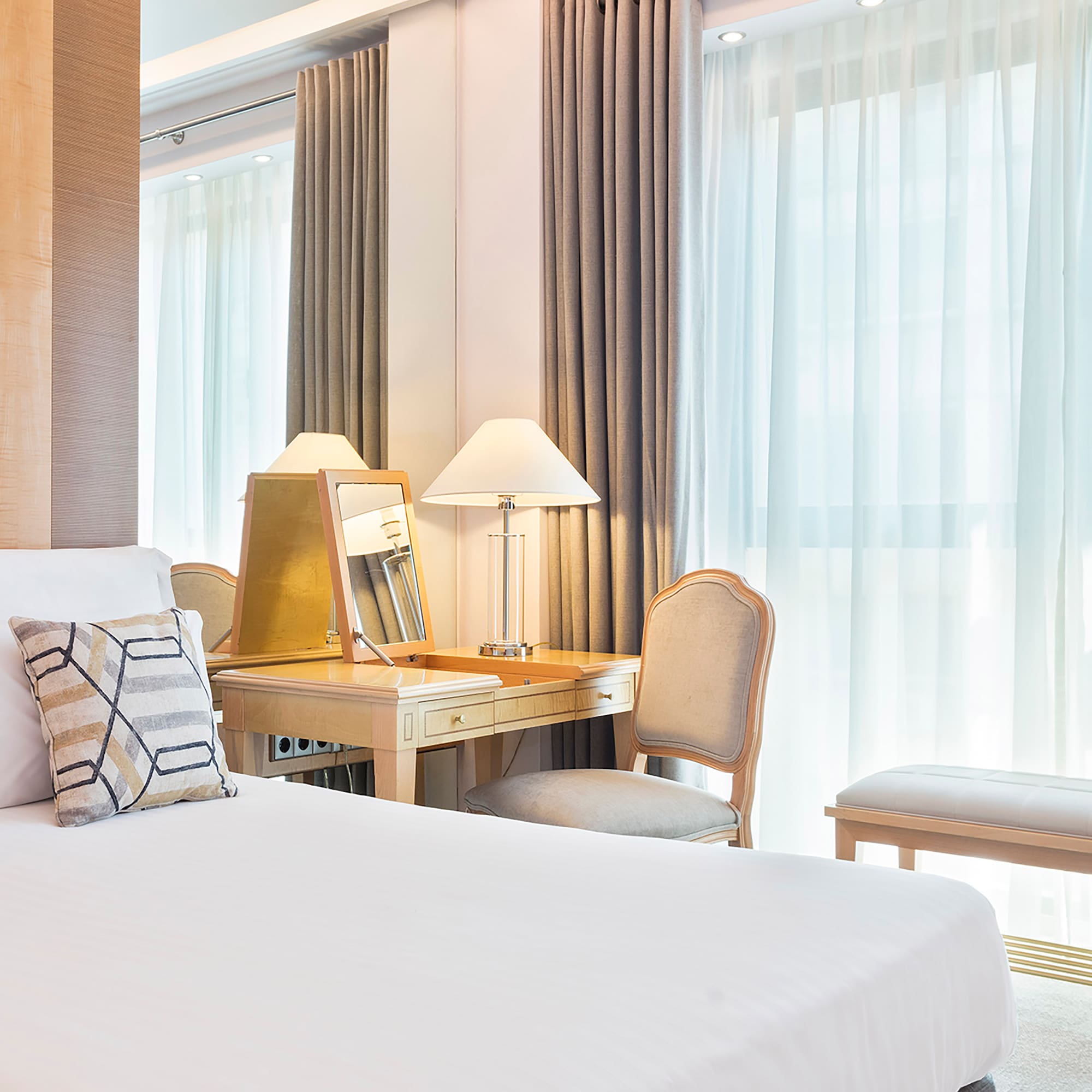 a bedroom with a desk and a mirror