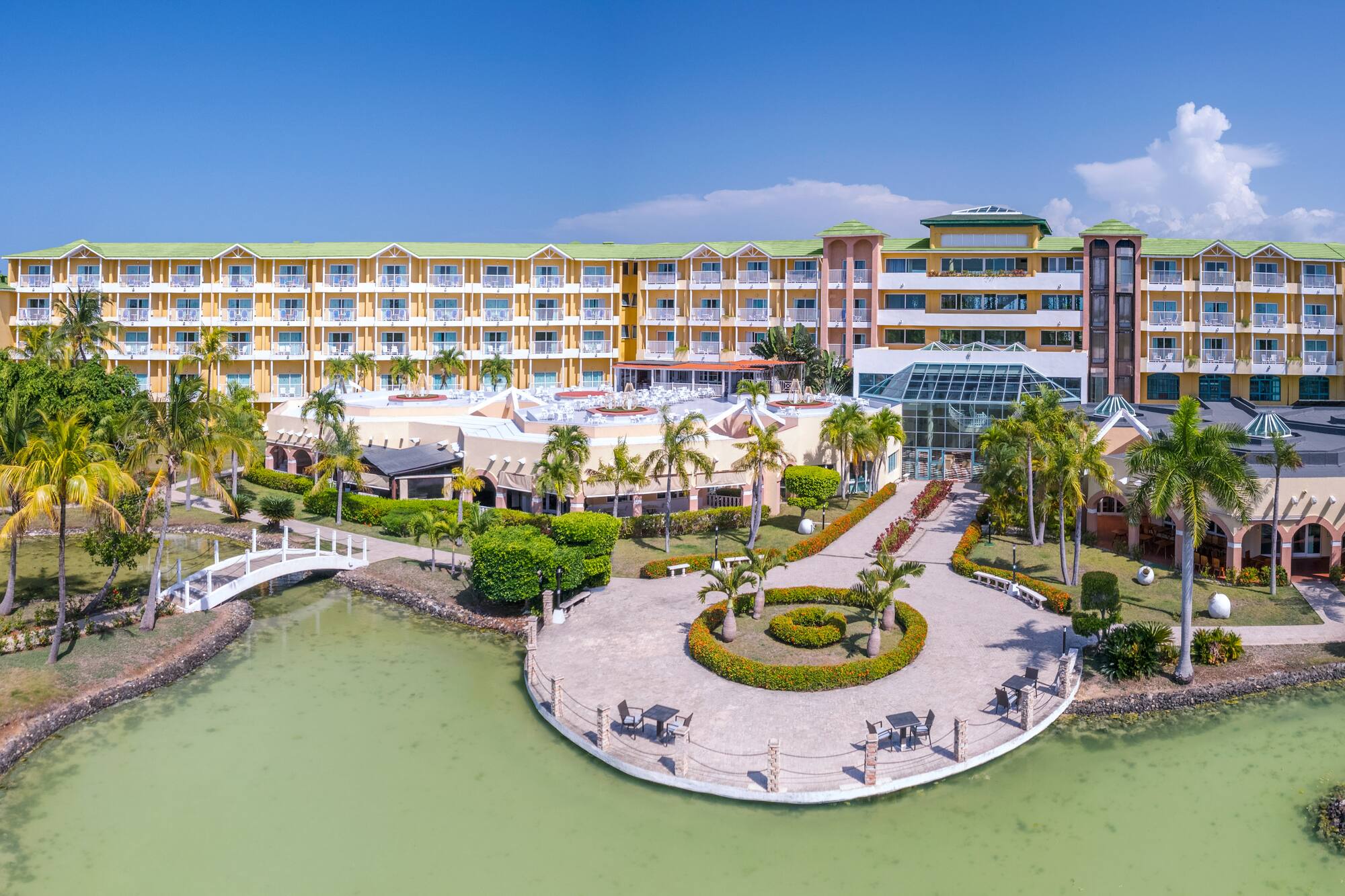 a building with a body of water and a walkway