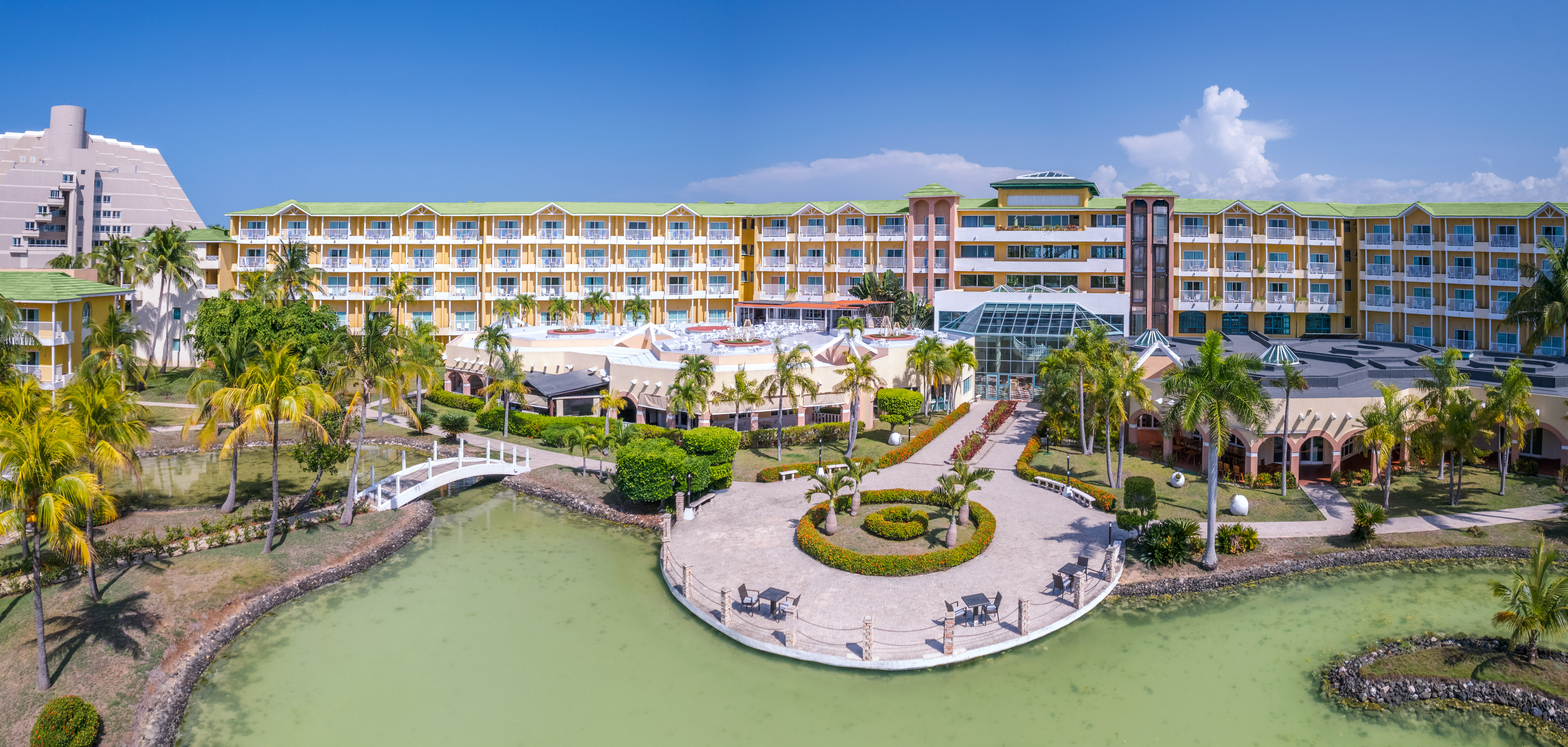 a building with a body of water and a walkway