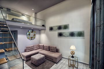 a living room with a couch and a lamp