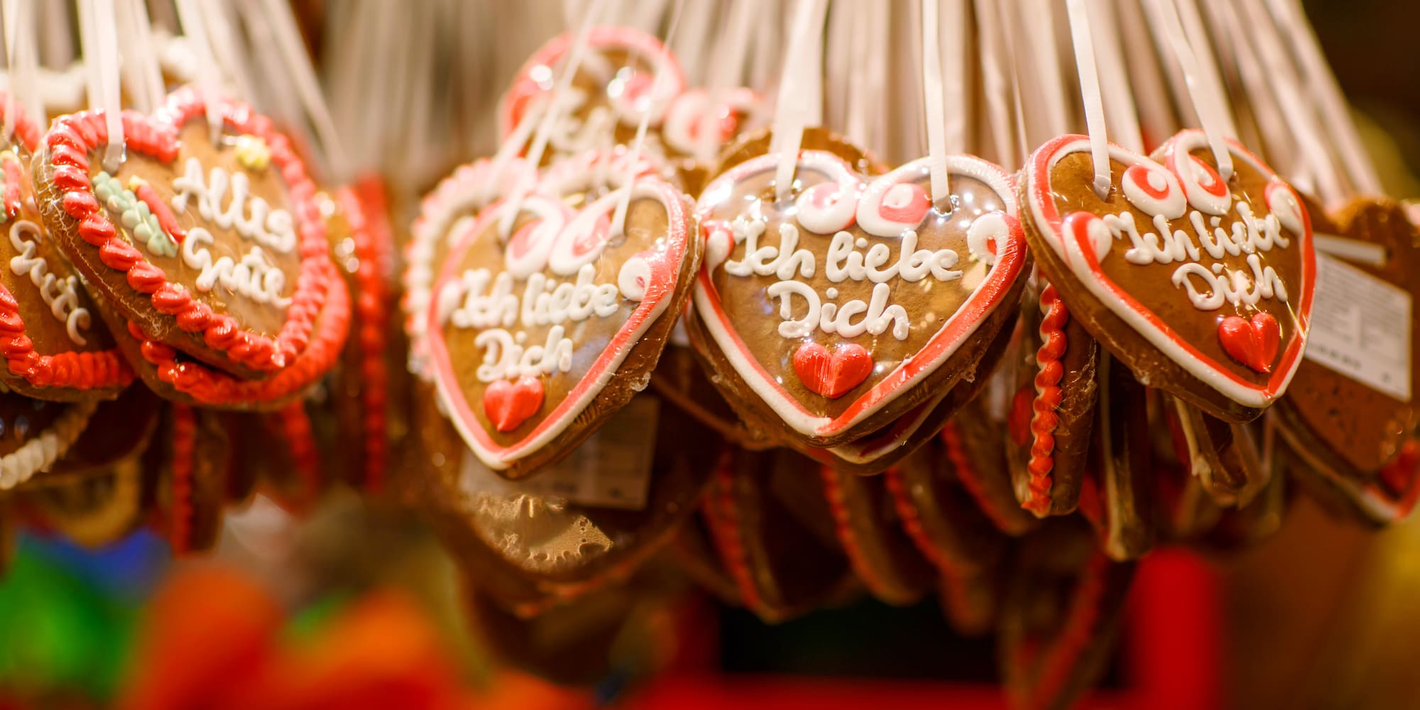 Hanging German gingerbread hearts with "Ich liebe Dich" icing.