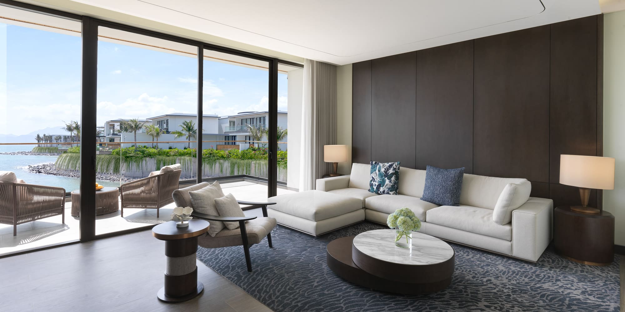 a living room with a large glass wall and a large couch