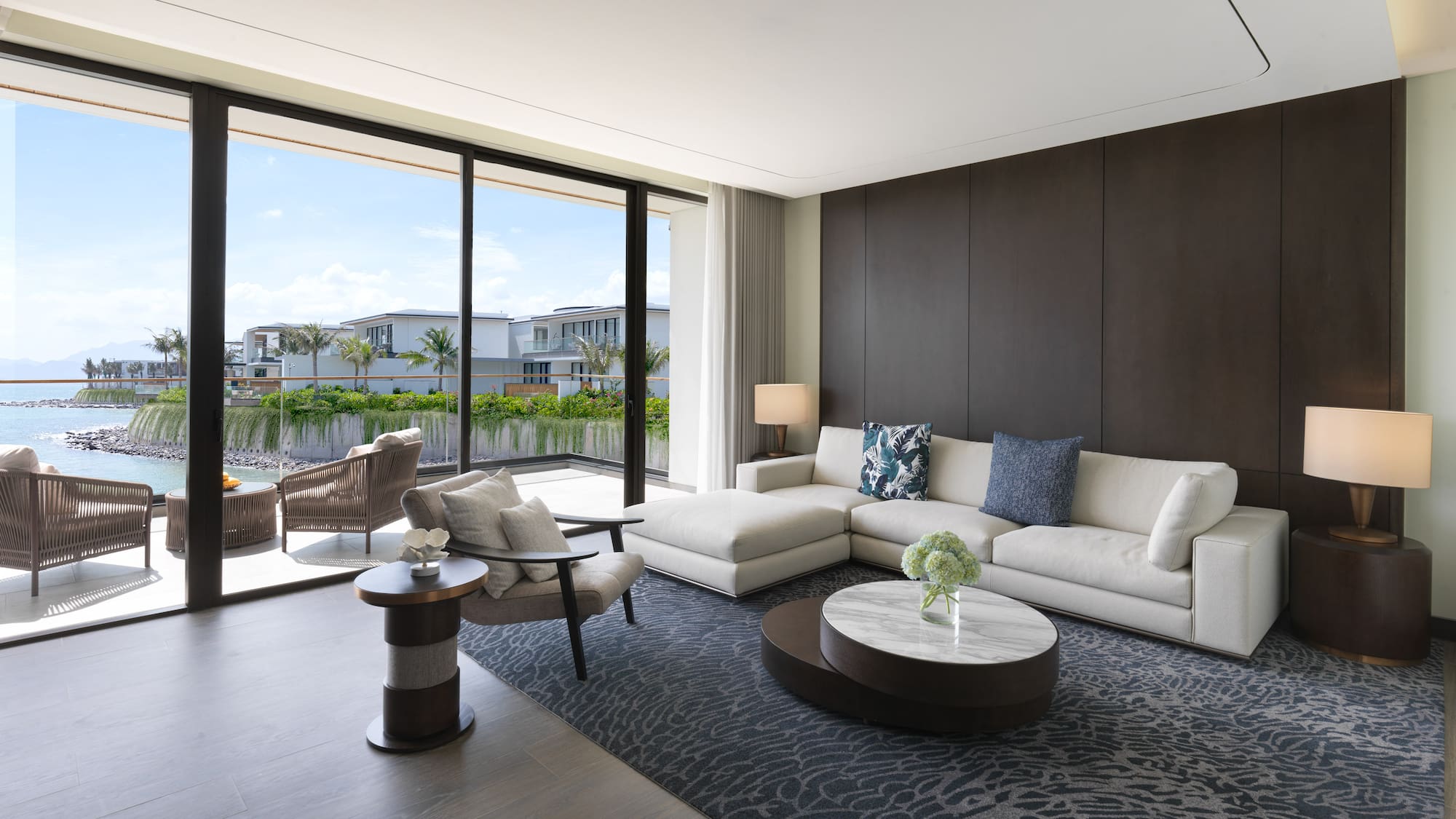 a living room with a large glass wall and a large couch