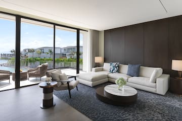 a living room with a large glass wall and a large couch