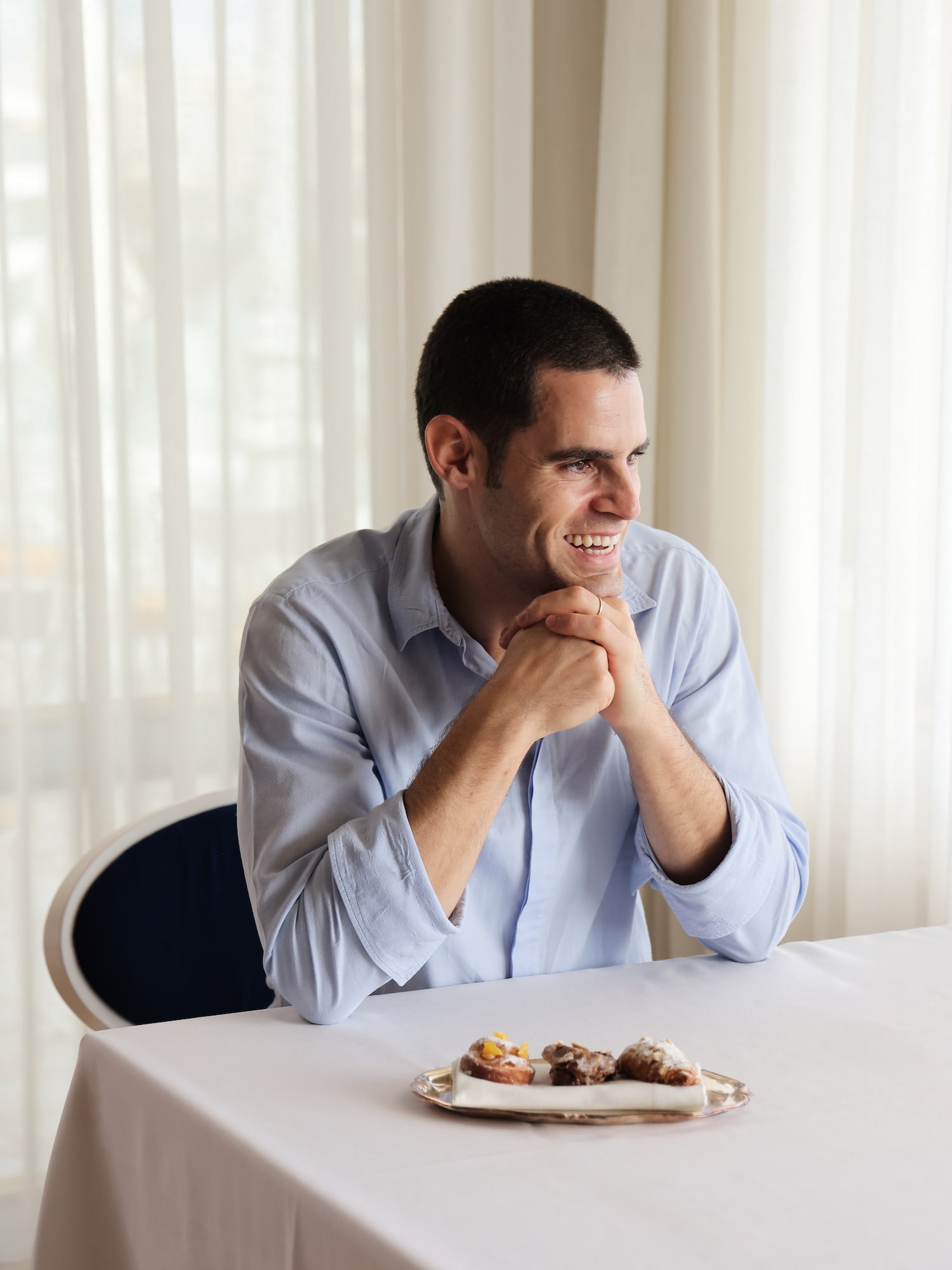 a man sitting at a table with food on it