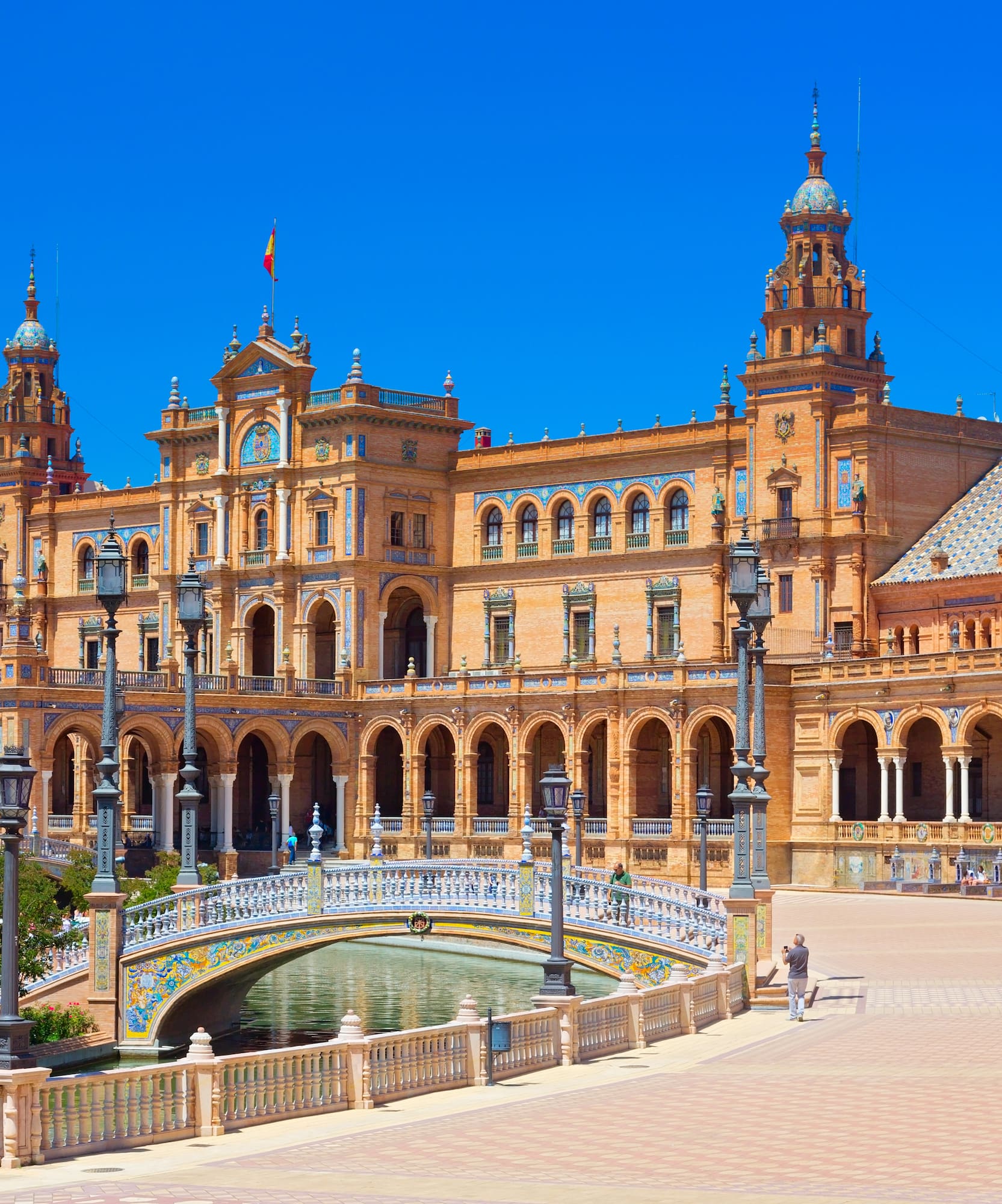 a large building with a bridge and a river