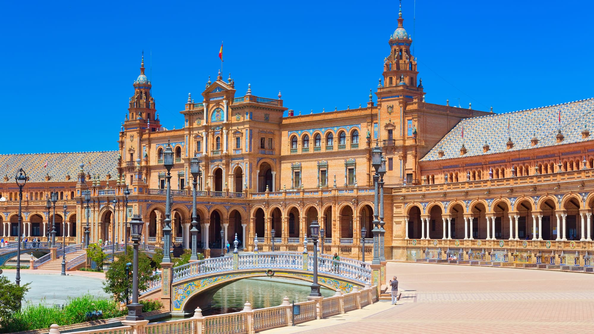 a large building with a bridge and a river