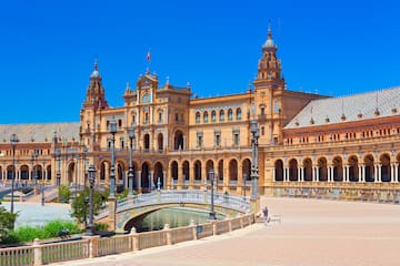 a large building with a bridge and a river