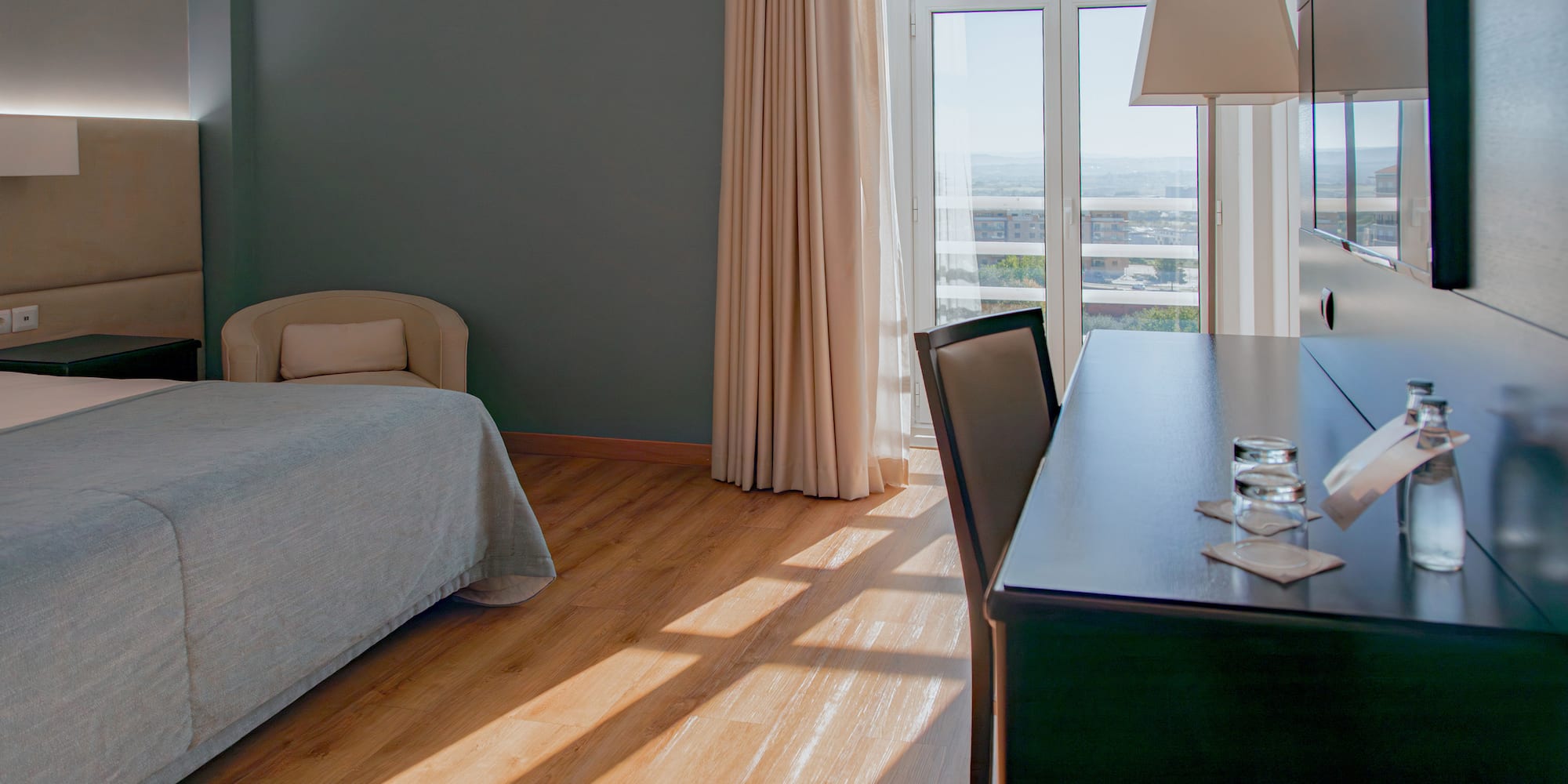 a room with a desk and a bed