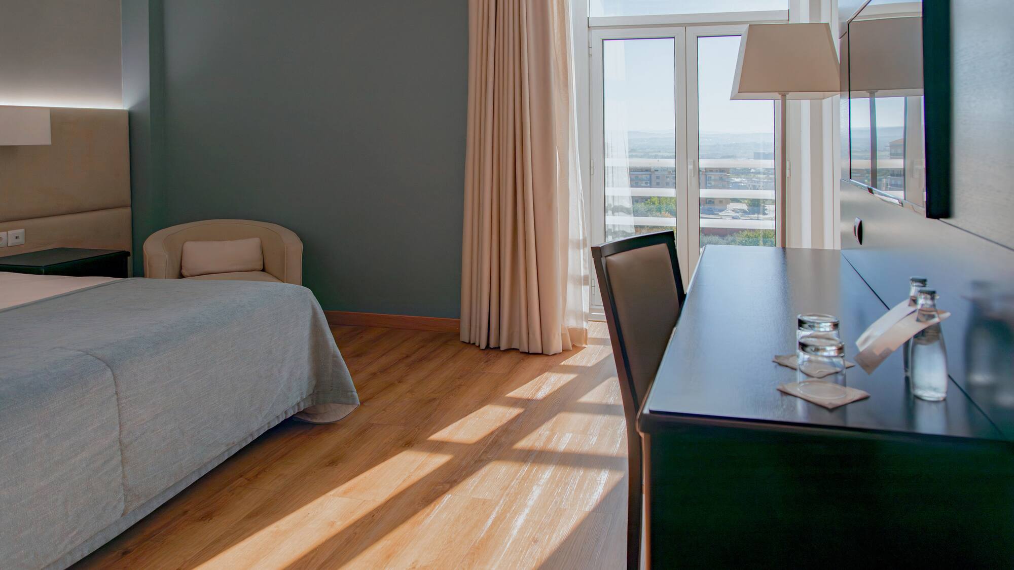 a room with a desk and a bed