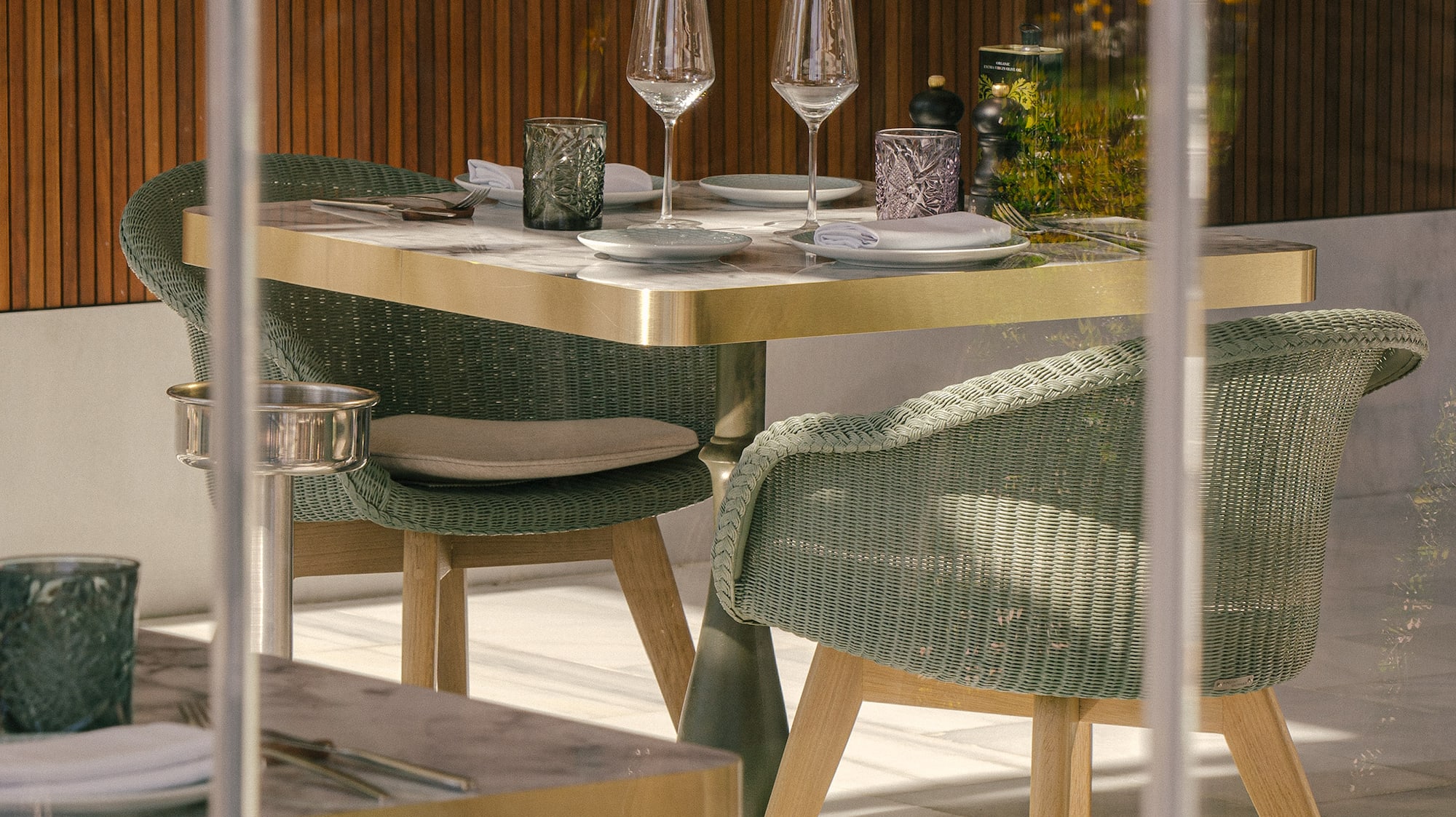 a table with wine glasses and chairs