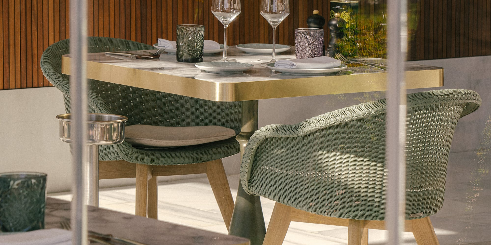 a table with wine glasses and chairs