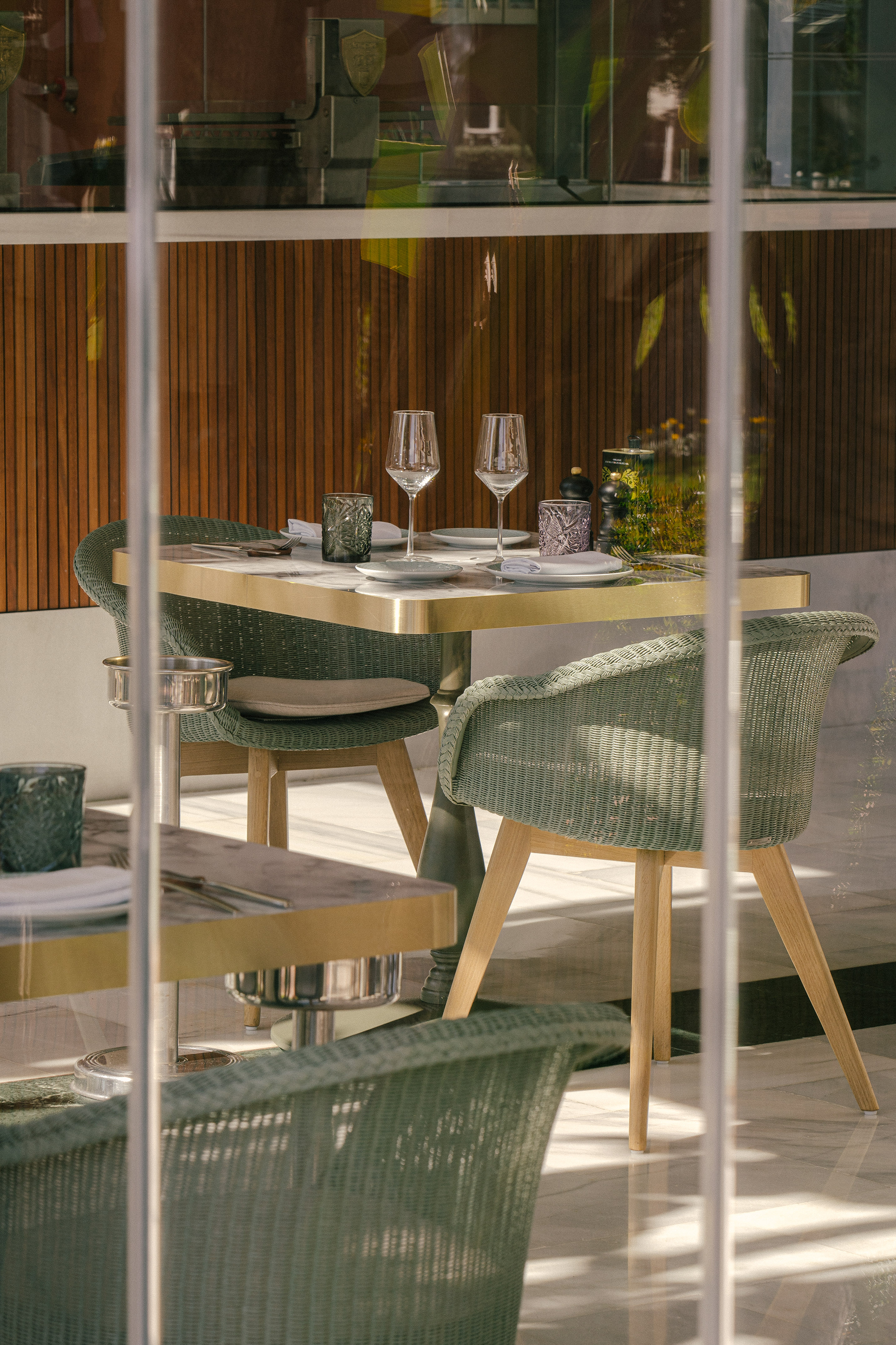 a table with wine glasses and chairs