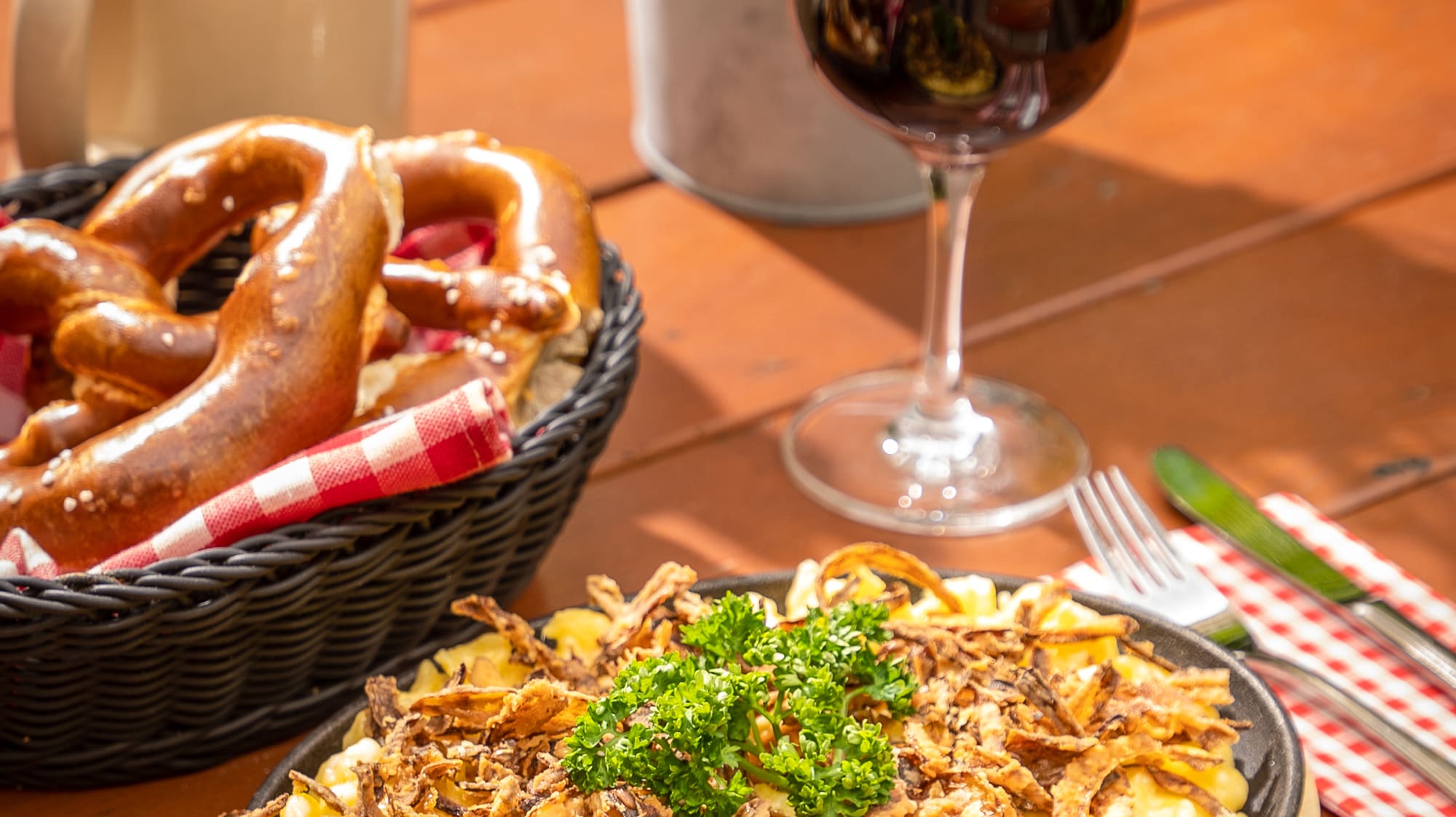 food on a plate next to a glass of wine