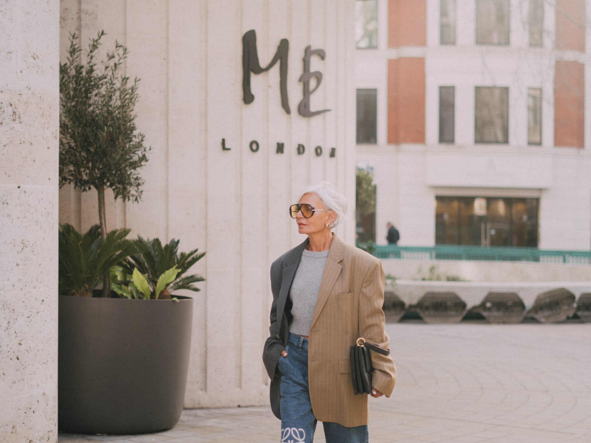 a woman wearing sunglasses and a jacket