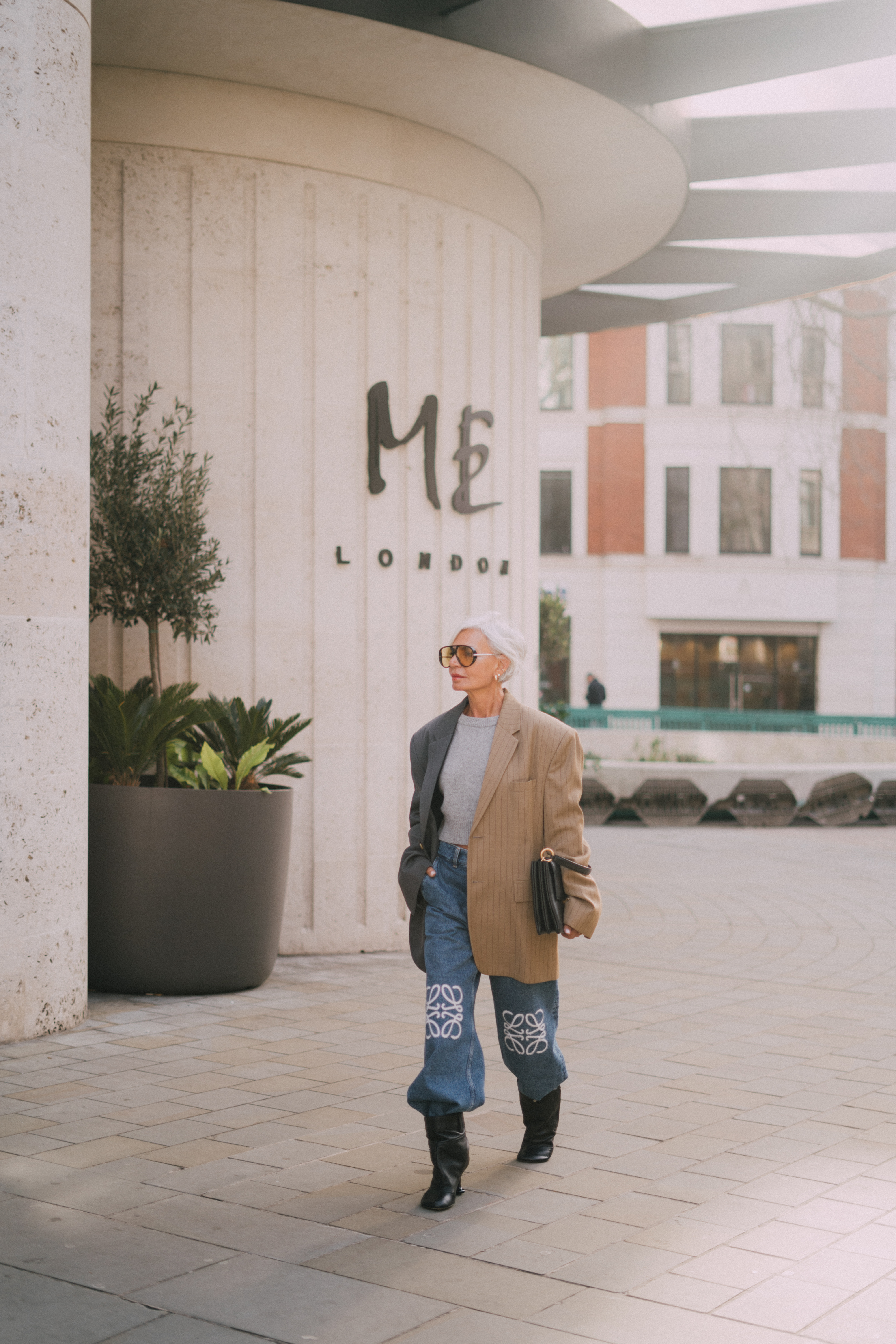 a woman wearing sunglasses and a jacket