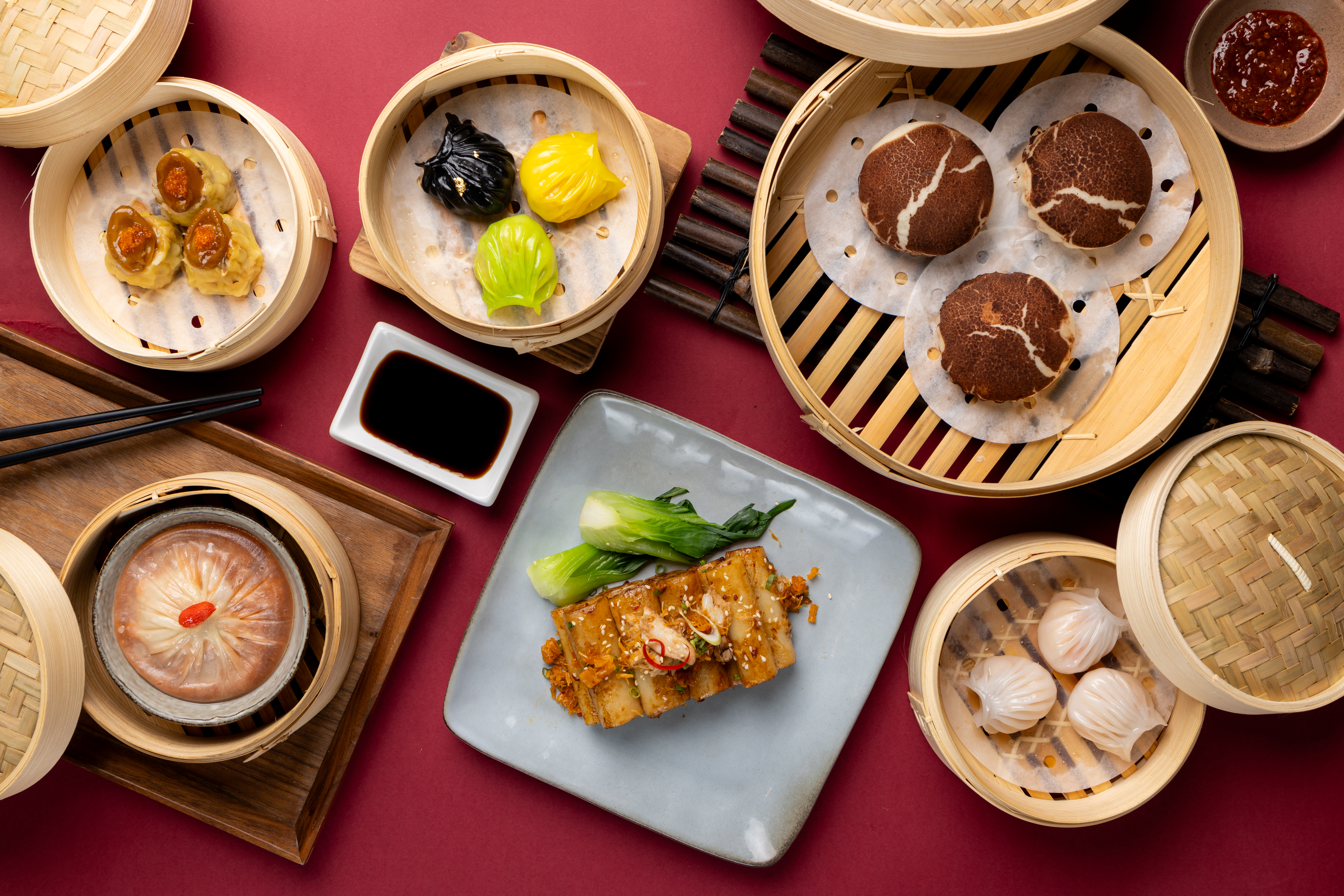 a group of dim sum baskets with food in them