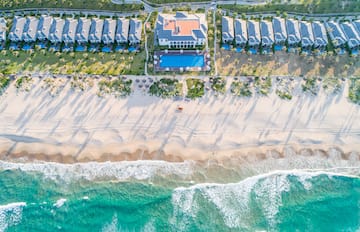 a beach with houses and a pool