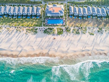 a beach with houses and a pool