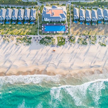 a beach with houses and a pool