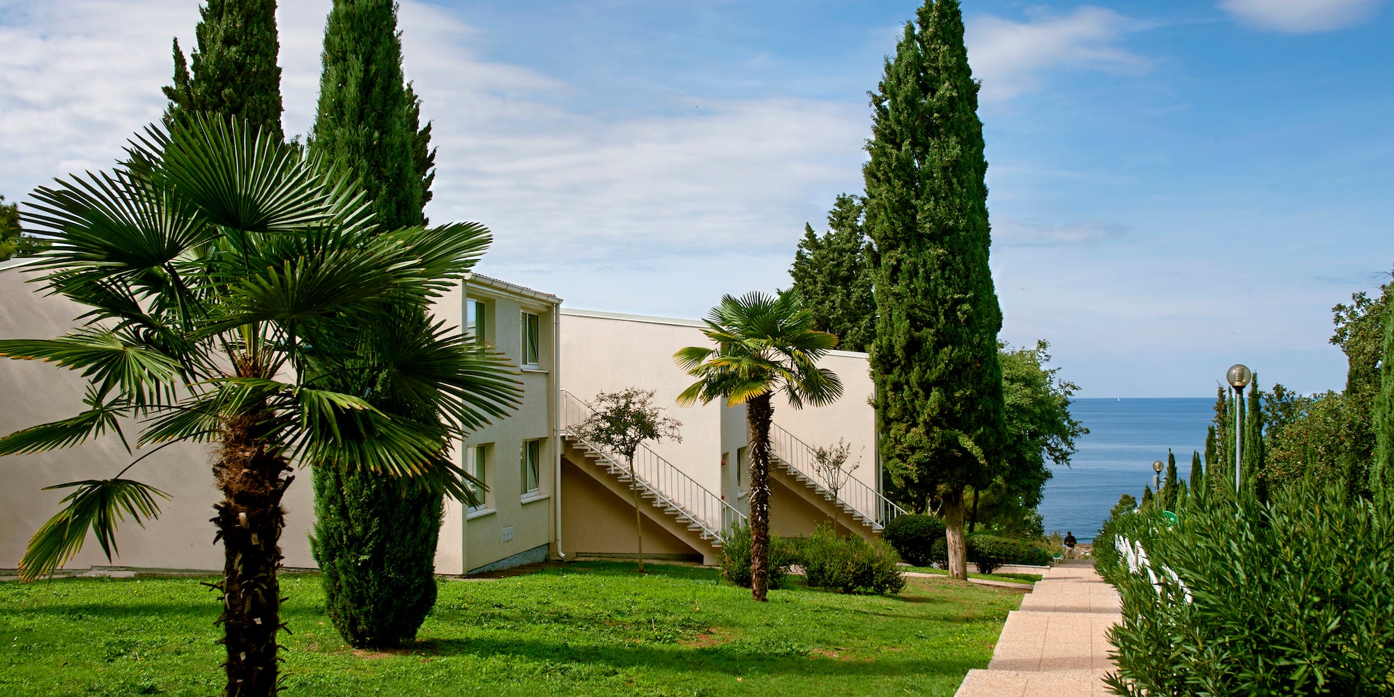 a building with trees and grass