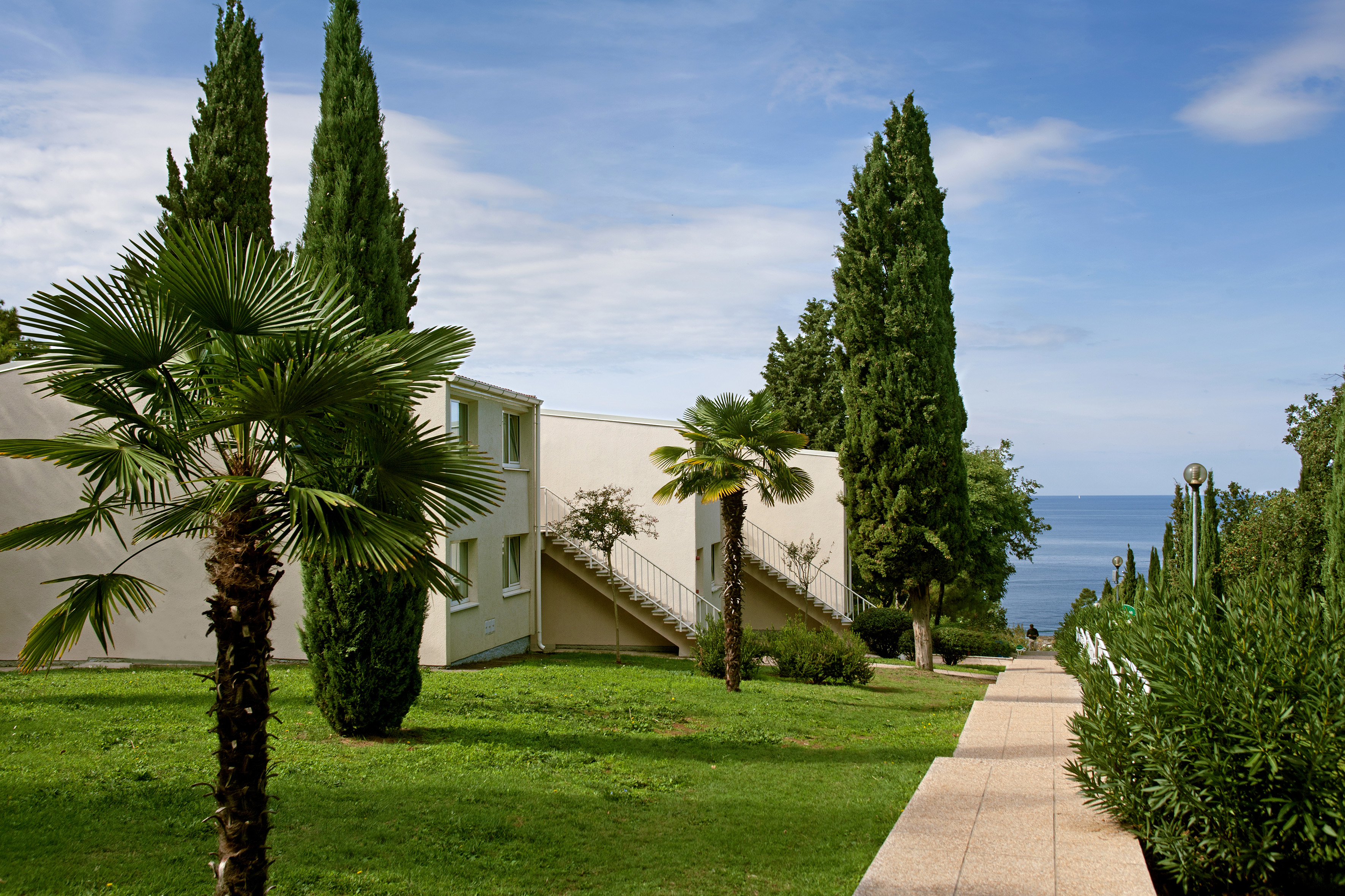 a building with trees and grass