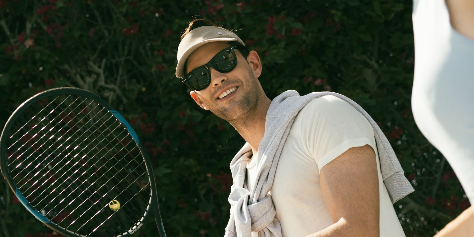 a man and woman holding tennis rackets
