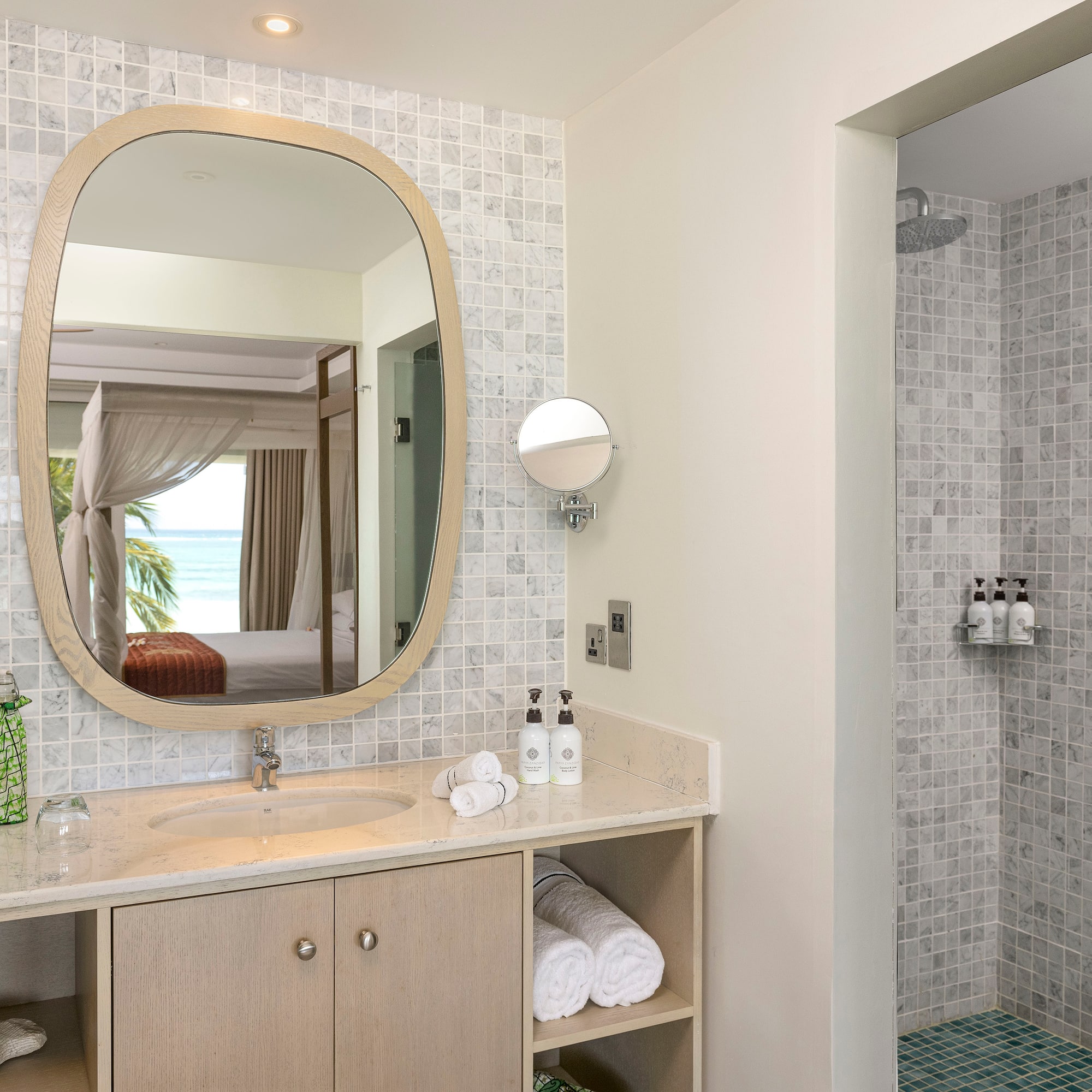 a bathroom with a mirror and a shower