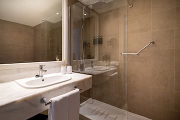 a bathroom with a shower and sink