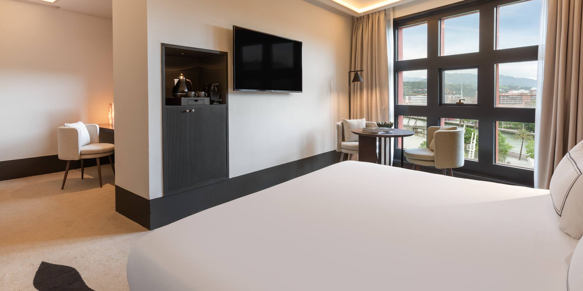 a room with a bed and a television