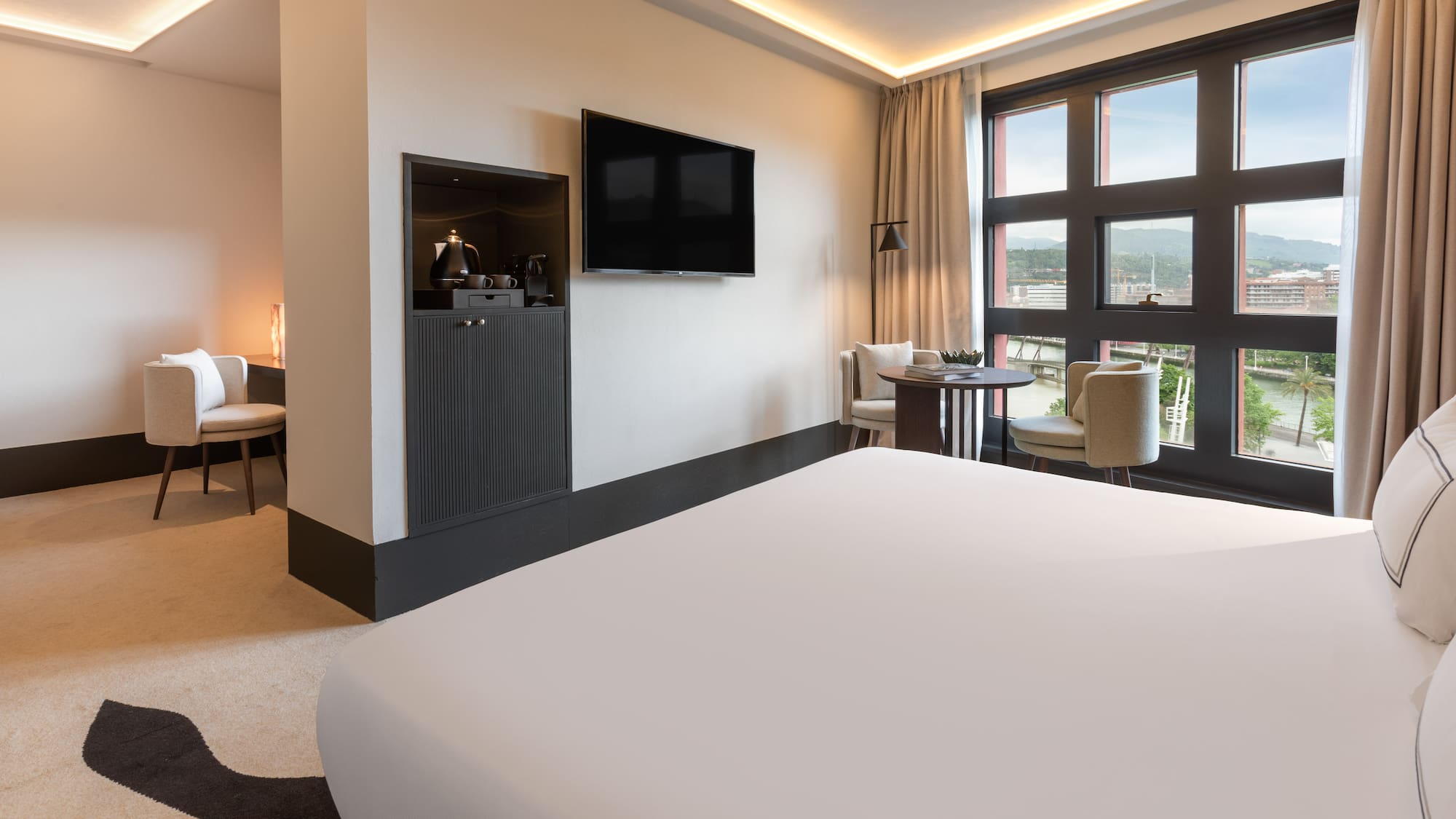 a room with a bed and a television