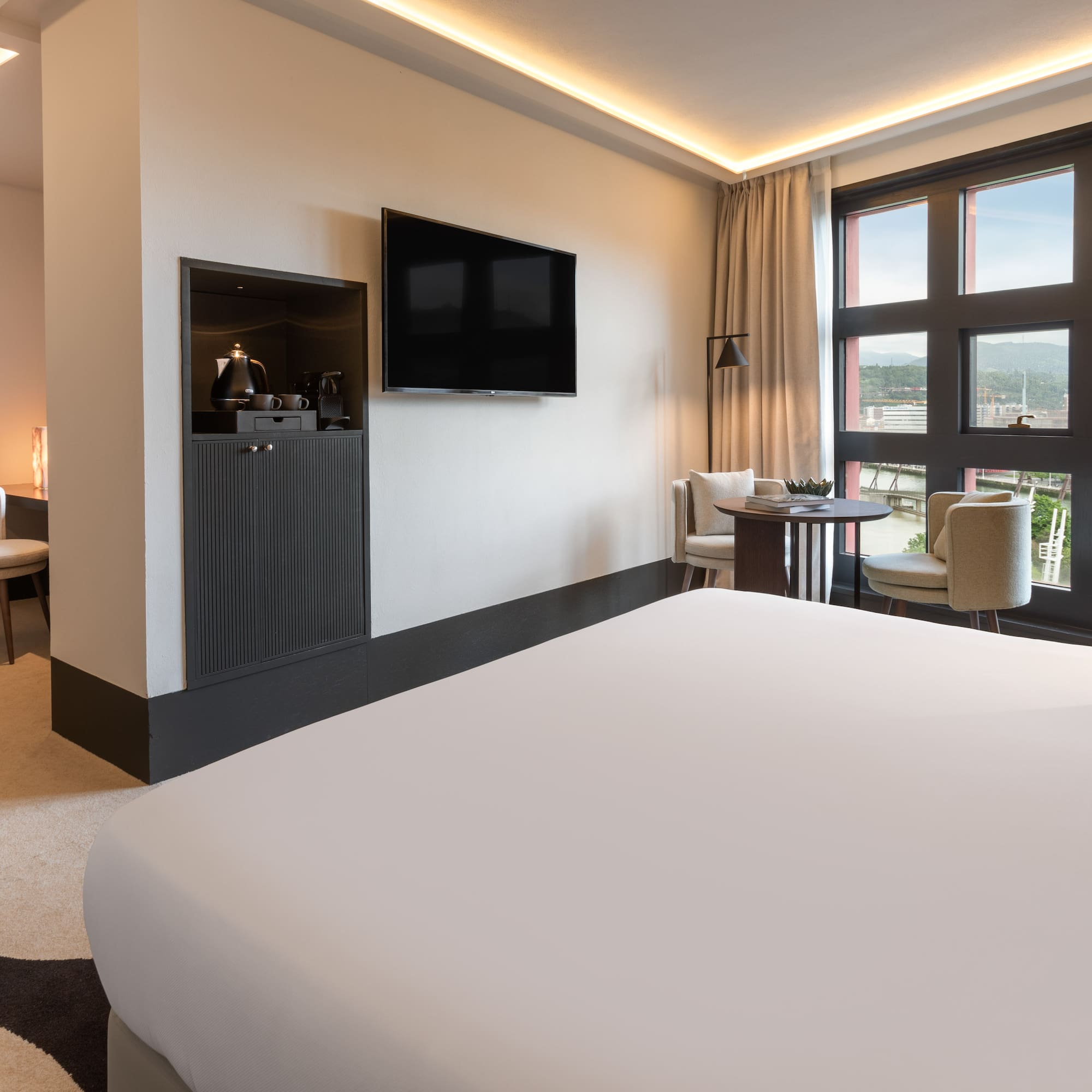 a room with a bed and a television