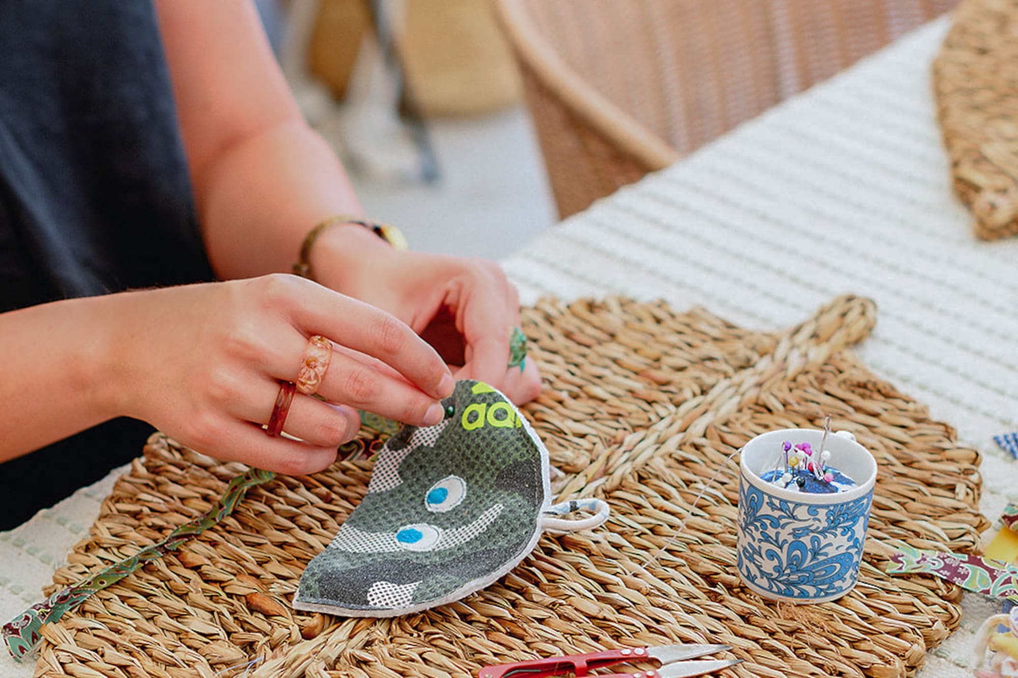 a person sewing a leaf